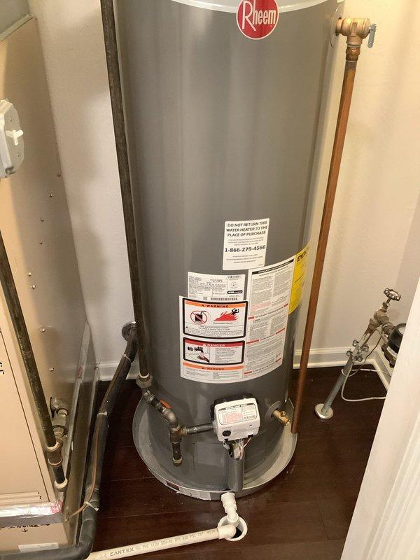 Completed installation of a new Rheem water heater in 25-year-old home, replacing an existing Whirlpool unit. Installation included proper copper pipe connections, ventilation ductwork, and placement of the unit on a leak-protection pan. System was tested and verified to be functioning correctly with all connections secure.