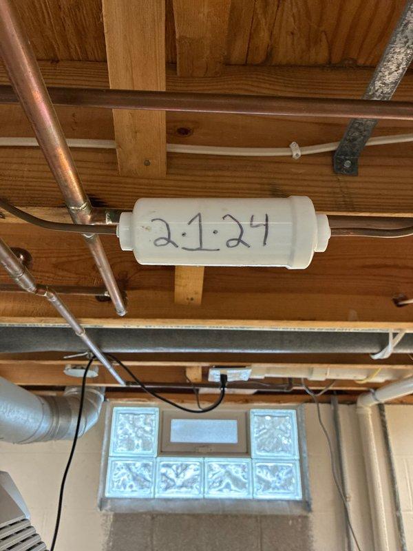 Performed scheduled maintenance on 9-year-old cooling system. Inspected control board functionality (confirmed by illuminated LED indicator) and documented refrigerant line filter installation with service date. System operating normally with no issues detected.