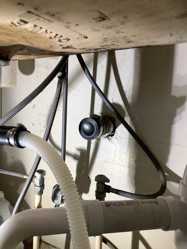 Completed kitchen drain line replacement, removing old galvanized and cast iron piping. Installed new basket strainer, tubular dishwasher tailpiece and trap, then ran new 2" PVC piping with air admittance valve for proper venting. All new piping was properly secured to joists and connected to existing PVC drain line.