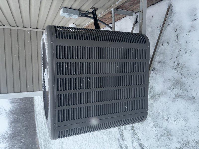 Performed comprehensive furnace and AC maintenance service on 10-year-old AC system. Inspected outdoor condenser unit, which was found in good condition despite snow accumulation at base. Conducted electrical testing using UEi DL379T clamp meter, checking amperage readings (13.3A) and verifying proper operation of capacitor and terminal connections. Extended MVP service agreement through 2025.