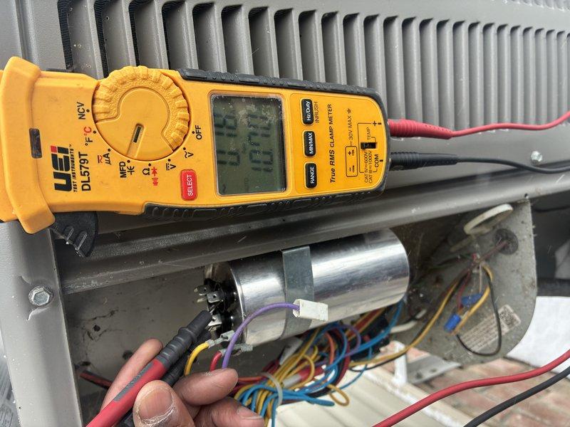 Performed comprehensive furnace and AC maintenance service on 10-year-old AC system. Inspected outdoor condenser unit, which was found in good condition despite snow accumulation at base. Conducted electrical testing using UEi DL379T clamp meter, checking amperage readings (13.3A) and verifying proper operation of capacitor and terminal connections. Extended MVP service agreement through 2025.