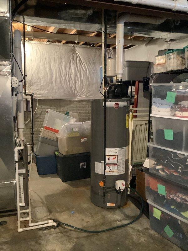 Conducted assessment of 50-gallon power vent water heater requiring replacement. Provided quote for new natural gas MVP water heater with power vent capability. Documented existing installation environment in basement utility area with proper venting and connection points for efficient replacement planning.