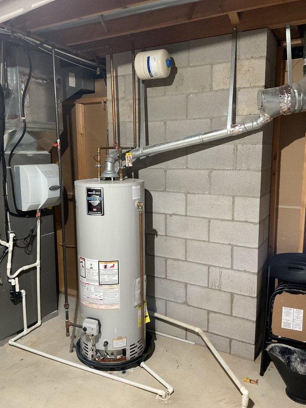 Successfully installed new 50-gallon Branford white water heater with proper shut-off valve and expansion tank in basement utility area. Complete installation included connecting copper and PVC pipes to existing plumbing system and ensuring proper venting. System includes 6-year warranty and is functioning correctly alongside the home's water treatment system.