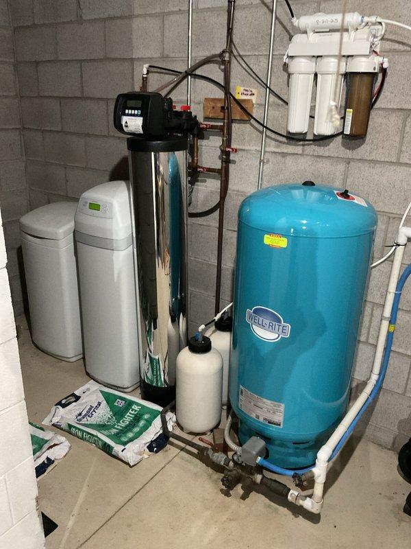 Successfully installed new 50-gallon Branford white water heater with proper shut-off valve and expansion tank in basement utility area. Complete installation included connecting copper and PVC pipes to existing plumbing system and ensuring proper venting. System includes 6-year warranty and is functioning correctly alongside the home's water treatment system.