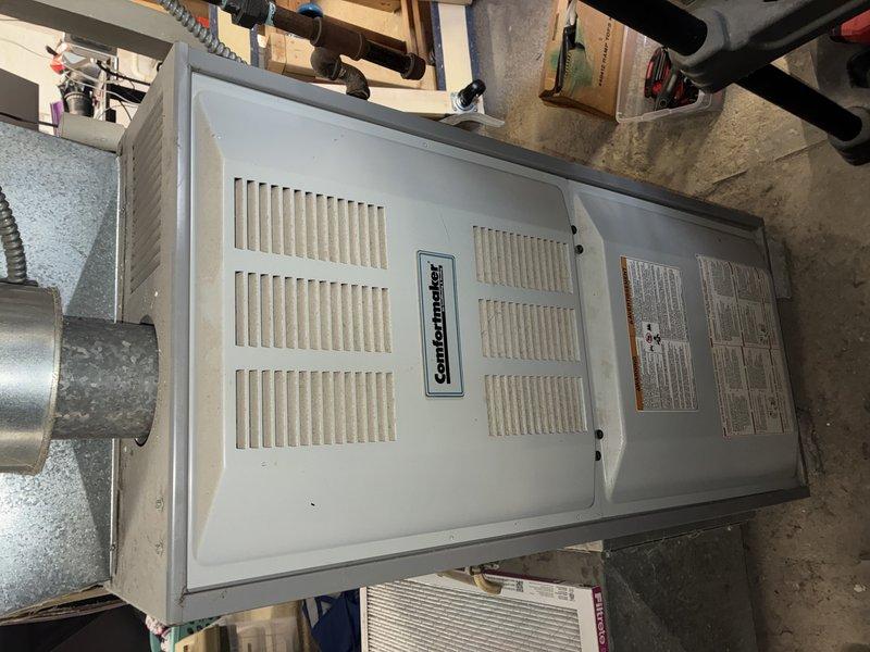 Performed routine maintenance service on 13-year-old Comfort Maker gas furnace located in basement utility area. Inspected ductwork connections and verified proper operation of the heating system. All components functioning normally with no issues identified.