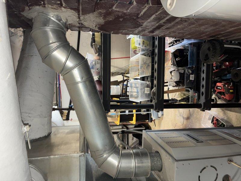Performed routine maintenance service on 13-year-old Comfort Maker gas furnace located in basement utility area. Inspected ductwork connections and verified proper operation of the heating system. All components functioning normally with no issues identified.