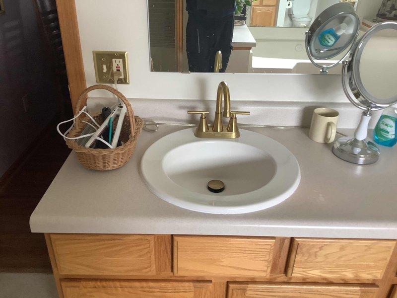 Replaced exhaust collar and gasket on water heater system, cutting exhaust pipe and adding 22-degree offset to restore proper venting functionality. Also installed new left side master bathroom lavatory faucet, replacing previous gold-colored fixture with all required components.