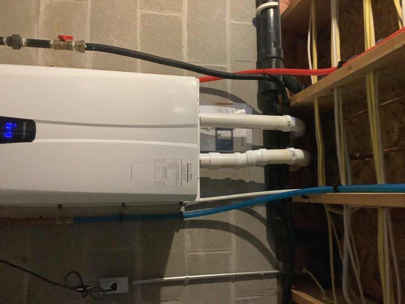 Replaced exhaust collar and gasket on water heater system, cutting exhaust pipe and adding 22-degree offset to restore proper venting functionality. Also installed new left side master bathroom lavatory faucet, replacing previous gold-colored fixture with all required components.