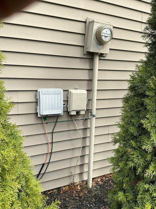 Conducted a site assessment for potential generator installation at a 1971 residential property. Evaluated existing electrical service entrance configuration, including meter and junction boxes mounted on exterior vinyl siding. Inspected available workspace in garage/workshop area to determine appropriate placement and installation requirements for the new generator system.