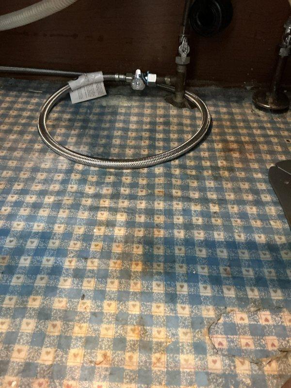 Installed new straight stops for hall bathroom toilet and master bathroom, requiring removal of toilet and unsoldering of existing stops. Replaced hall bathroom toilet components including fill valve, supply line, and flush valve gasket to address periodic leaking. Installed new 19.5-inch toilet in master bathroom with new supply lines for vanity. Updated kitchen dishwasher valve and supply line, and rebuilt corroded pipes below water meter to address leaking 1x3/4 elbow in basement.