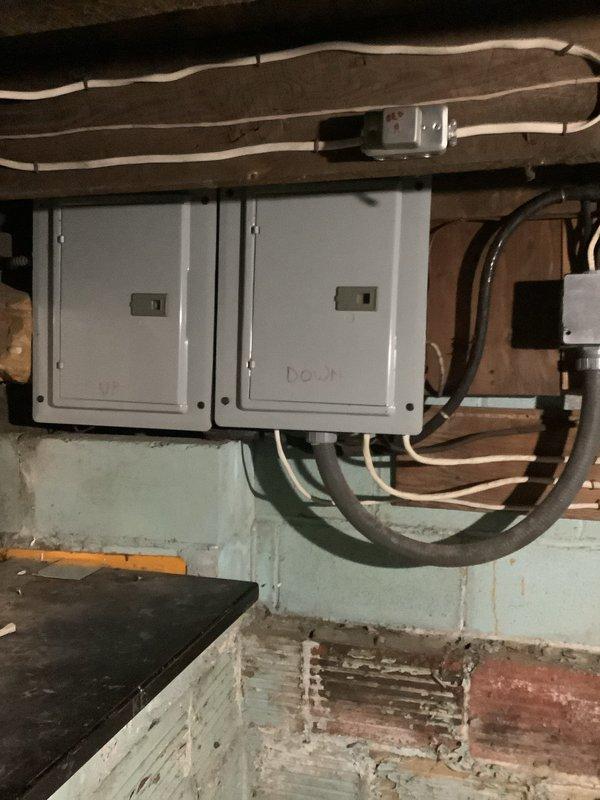 Diagnosed power loss affecting approximately 80% of lower apartment. Inspection revealed outdated electrical panels requiring replacement. Recommended installation of two new panels to restore full power distribution and installation of a new circuit to address the affected areas. Documented existing panel configuration and exterior meter connection for proper service restoration planning.