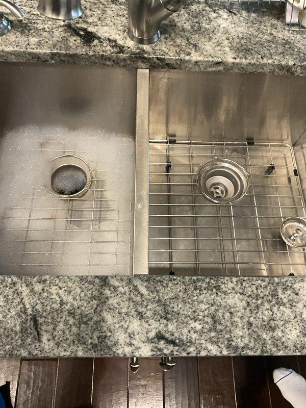 Responded to service call for a clogged kitchen sink drain and shower faucet temperature/dripping issues. Cleared the double-basin kitchen sink blockage using appropriate drain cleaning techniques, restoring proper drainage function. Inspected under-sink plumbing components including garbage disposal, drain lines, and supply connections - all were verified to be in good working condition with no leaks detected after service completion.