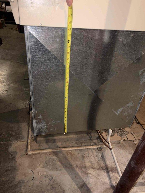Conducted leak search on existing HVAC system and took measurements of the unit (approximately 3 feet in height) to prepare replacement estimate. System is installed in basement utility area with limited clearance, requiring careful dimensional assessment for proper replacement unit specification.