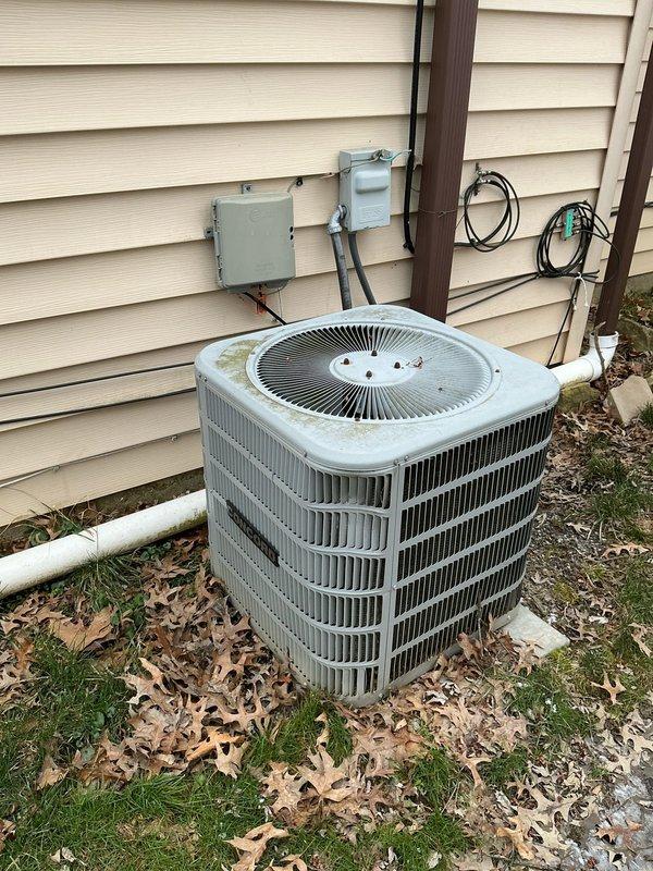 Performed assessment for furnace and AC replacement. Current outdoor condenser unit shows signs of weathering and possible mold growth, positioned on concrete pad with aging electrical connections. Inspection of attic revealed compromised ductwork with inadequate insulation and sagging fiberglass batts between joists, indicating potential efficiency issues throughout the system.