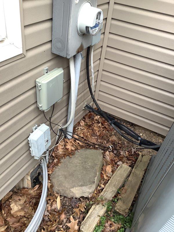 Conducted heat pump estimate, documenting existing furnace unit in utility area with appropriate ventilation connections and electrical components. Inspected exterior electrical service including meter setup and conduit connections. Noted current system configuration to prepare comprehensive replacement proposal.