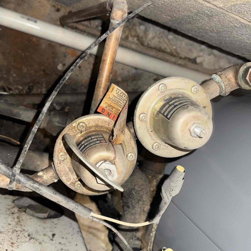 Responded to no-heat call for an aging boiler system in vacant condo. Inspection revealed significant dust accumulation and wear on the circulation components including corroded copper piping and valve housings. Restored heat functionality by cleaning system components and reestablishing proper water circulation through the boiler.