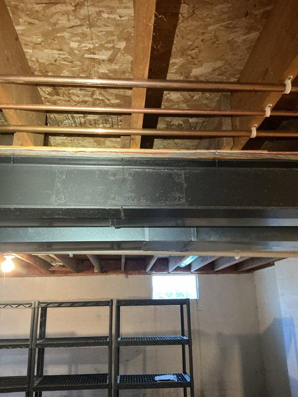 Performed comprehensive gas leak investigation in response to customer-reported odor. Conducted pressure test on existing gas lines and inspected exposed piping in unfinished areas, including basement utility space with copper lines and wall cavity with PVC piping. No active leaks detected; provided customer with quote for requested gas line relocation for kitchen stove as discussed with on-site contractor.