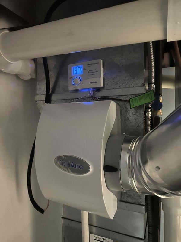 Successfully installed a 90% efficient furnace system with integrated AprilAire humidifier and digital humidity controller. Completed proper PVC venting through confined service space with all connections secured per manufacturer specifications. System tested and functioning correctly with humidity level at 13.8%.
