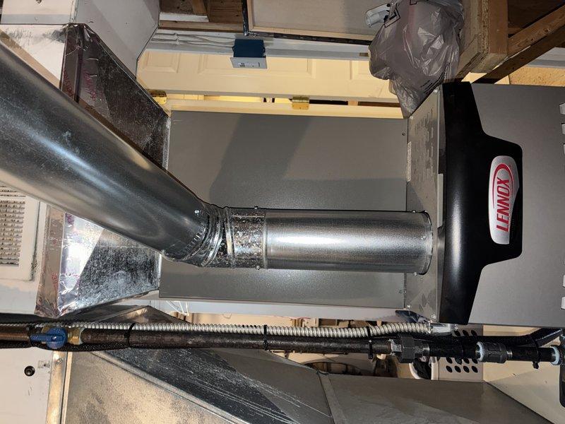 Performed routine maintenance on Lennox heating system for MVP customer. Inspected unit installation, ductwork connections, and ventilation components, confirming all elements are properly secured with appropriate metal tape at connection points. Visual examination of heat exchanger fins showed minor dust accumulation but overall good operating condition.