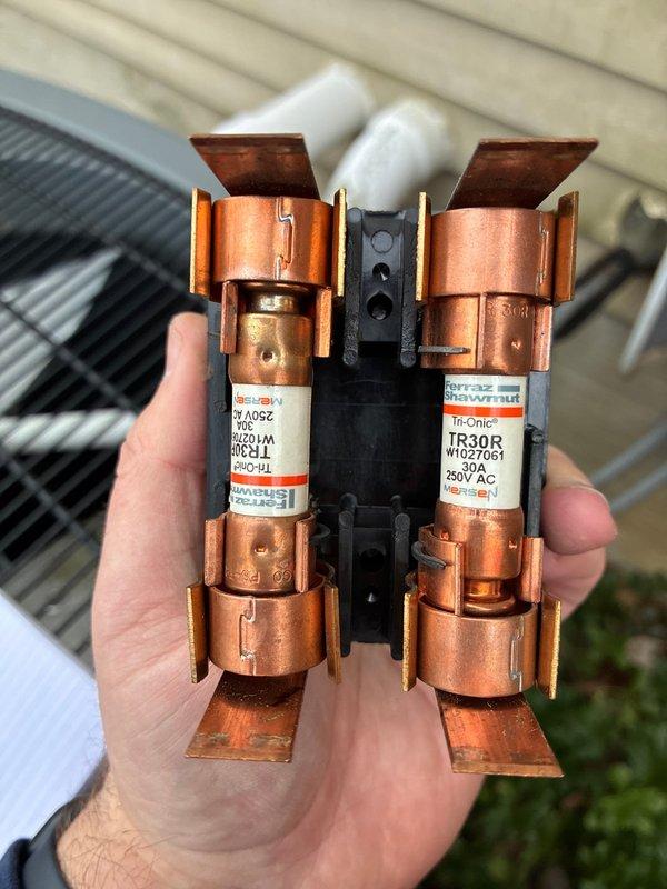 Performed scheduled AC tune-up service on a Goodman HVAC system. Inspected and verified proper condition of Tri-Onic TR30R fuses (250V AC) in the disconnect box. Examined PVC intake and exhaust ventilation configuration, confirming all connections were secure and properly installed.