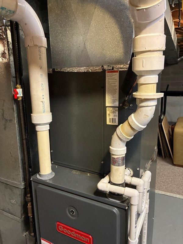 Performed scheduled AC tune-up service on a Goodman HVAC system. Inspected and verified proper condition of Tri-Onic TR30R fuses (250V AC) in the disconnect box. Examined PVC intake and exhaust ventilation configuration, confirming all connections were secure and properly installed.
