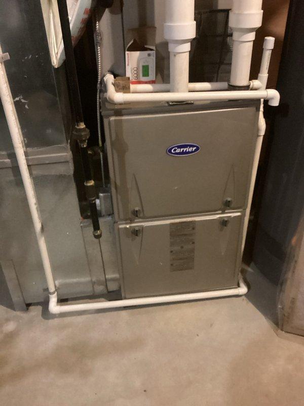 Performed scheduled MVP Heating maintenance service on a Carrier furnace system. Conducted thorough inspection of all components, including PVC ventilation/drainage assembly and control systems. Filter was examined showing normal wear pattern with some dust accumulation; cleaned or replaced as needed to ensure optimal system performance.