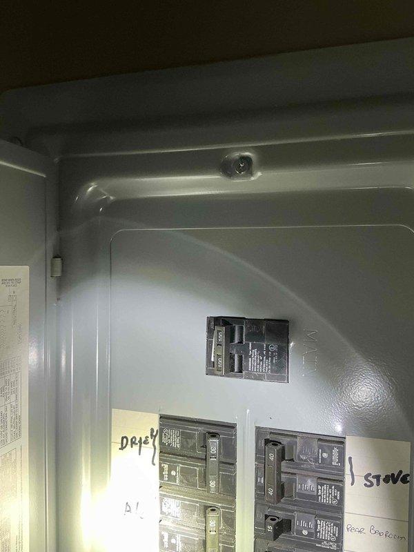 Conducted electrical panel assessment for generator installation compatibility. Evaluated existing 200A service panel with labeled circuits for dryer, stove, and kitchen. Documented current breaker configuration to determine appropriate transfer switch options and load management requirements for proposed generator system.