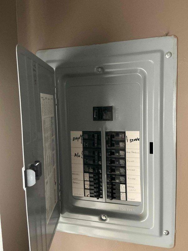 Conducted electrical panel assessment for generator installation compatibility. Evaluated existing 200A service panel with labeled circuits for dryer, stove, and kitchen. Documented current breaker configuration to determine appropriate transfer switch options and load management requirements for proposed generator system.