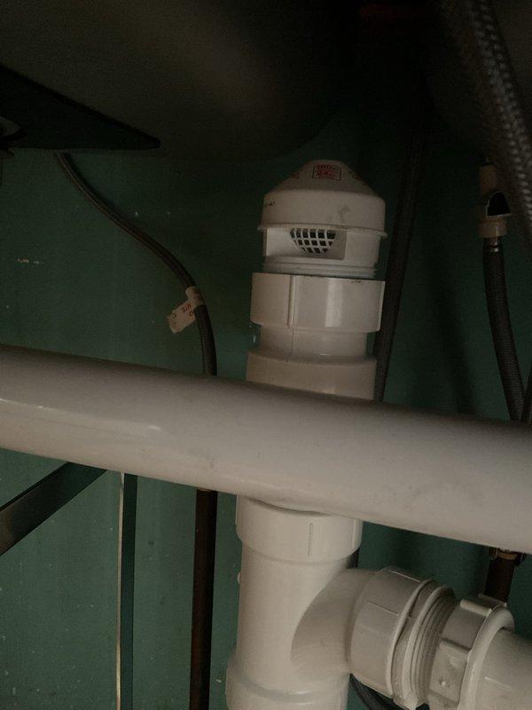 Successfully replaced the galvanized kitchen drain line with new PVC components, including installation of a sanitary tee and air admittance valve above the trap arm connection. Snaked kitchen drain from cabinet to basement lateral to clear blockage and ensure proper drainage. Completed full rebuild of drain system with proper connections and venting for optimal performance.