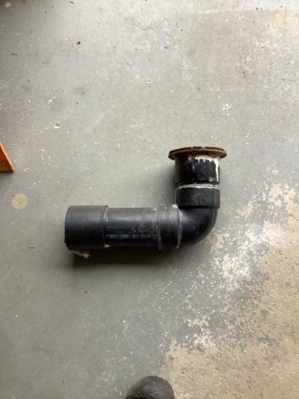 Successfully cut exposed 3" ABS line in garage and re-piped with new toilet flange for upstairs bathroom. Completed installation of white toilet on protective moisture barrier over concrete flooring, ensuring proper connection to the newly installed plumbing system.