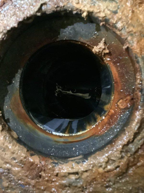 Successfully installed new American Standard Champion toilet with round bowl and comfort height. Replaced corroded drain pipe and installed new toilet flange on marble-patterned floor. Completed connection of water supply line to shut-off valve, ensuring proper function of the new fixture.