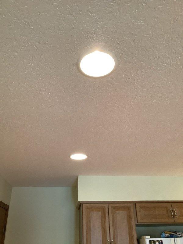 Responded to service call for non-operational recessed light fixture in kitchen ceiling. Diagnosed and replaced faulty 6-inch recessed light in 49-year-old home. Verified proper functionality of both kitchen ceiling fixtures after installation, confirming even illumination throughout the space.