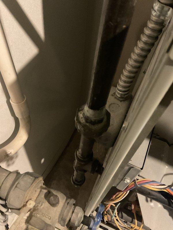 Completed MVP heating maintenance service. Inspected system components, noting some corrosion at pipe connection joint. Performed electrical testing with clamp meter showing 14 amp reading, confirming system is operating within normal parameters.