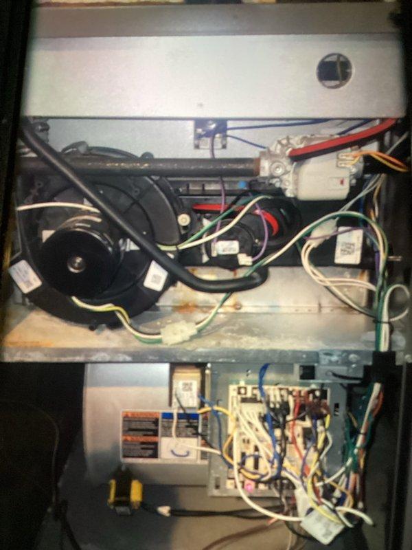 Performed maintenance service on heating system, confirming proper operation. Cleaned flame sensor, verified correct gas pressure, cleared air intake, and flushed drains. System passed combustion test. Replaced aging igniter showing white hot spots and installed new collector box to address leakage issues that were causing rust formation.