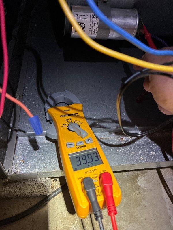 Performed comprehensive furnace tune-up including electrical testing with clamp meter (reading 39.93) of capacitor and associated components. Inspection revealed significant oxidation and corrosion on evaporator coil assembly, with copper tubing showing deterioration and rust formation on the metal framework. Customer opted to renew MVP service agreement.