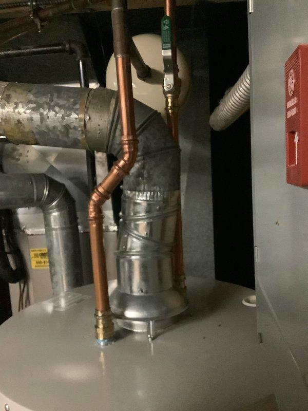 Replaced leaking outdoor spigot on 49-year-old home, requiring removal of Tyvek house wrap to access fixture. Installed new brass valve assembly with proper copper pipe connections and verified water flow with no leaks before completing the job.