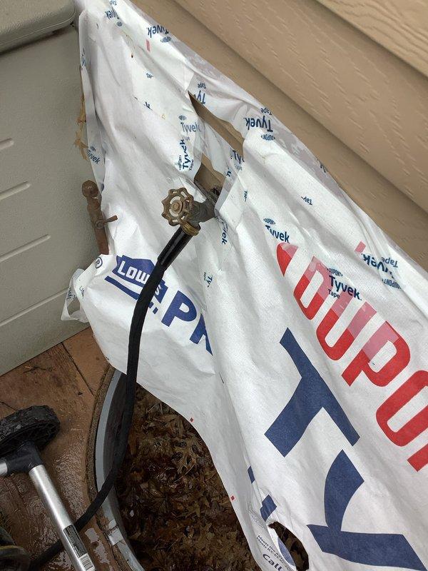 Replaced leaking outdoor spigot on 49-year-old home, requiring removal of Tyvek house wrap to access fixture. Installed new brass valve assembly with proper copper pipe connections and verified water flow with no leaks before completing the job.
