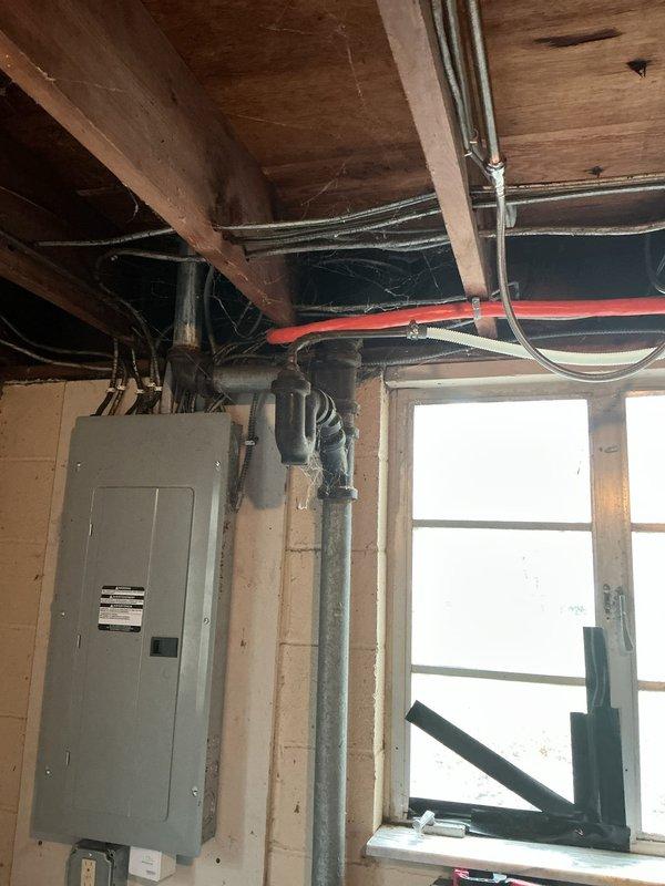 Responded to service call for clogged kitchen sink in 50-year-old home. Inspected drainage system in basement utility area, which revealed significant buildup in the main vertical waste stack. Successfully cleared obstruction using auger and restored proper drainage function throughout kitchen plumbing system.