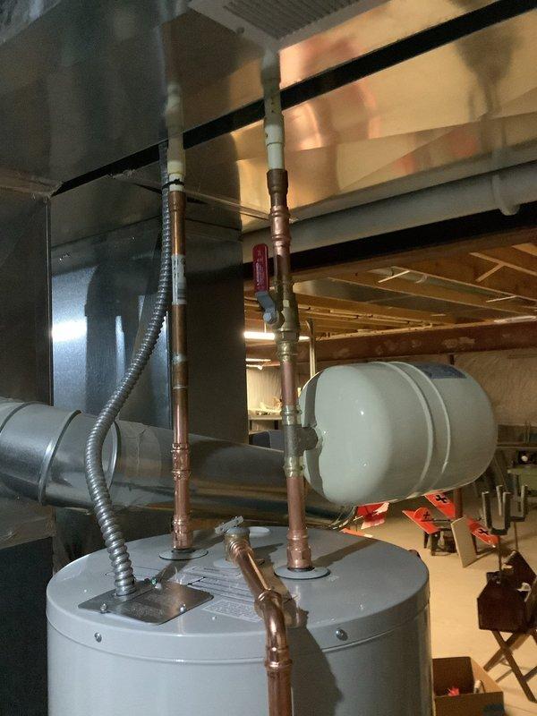 Successfully installed new 50-gallon electric tall water heater in utility area with proper connections to existing copper pipes. Installed unit on appropriate drain pan with PVC drain pipe connected to floor drain, and installed expansion tank as required. All connections were tested and verified for proper operation prior to completion.