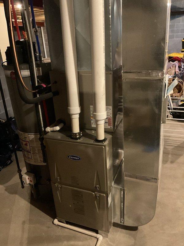Performed Early Bird A/C Tune-Up on Carrier system, inspecting both indoor furnace unit with connected PVC venting and the outdoor condenser unit. Completed full system diagnostic check, verified proper operation of components, and ensured optimal system performance as part of preventative maintenance service.