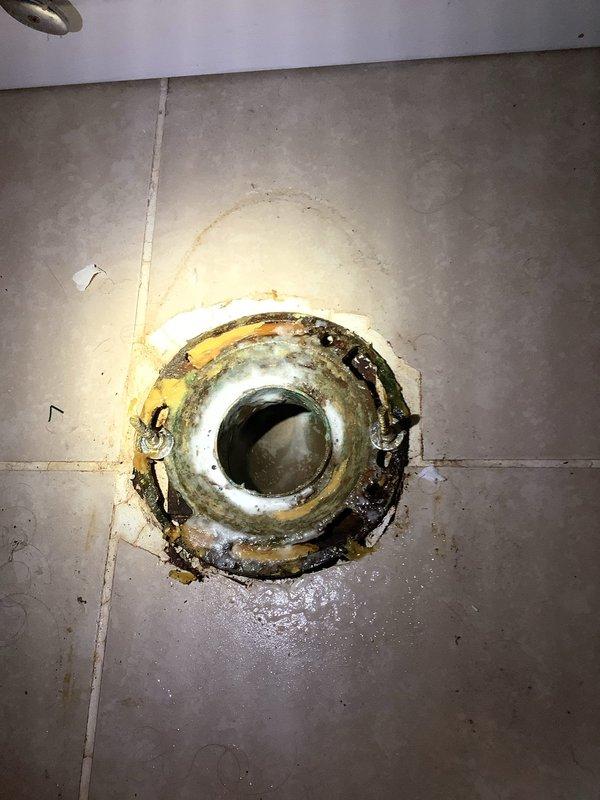 Responded to service call for recurring drain blockage affecting main bathroom fixtures (toilet, tub, sink). Inspected system and discovered severely corroded floor drain with significant mineral buildup causing restricted flow. Cleared blockage and advised customer on preventative maintenance options to avoid future clogs.