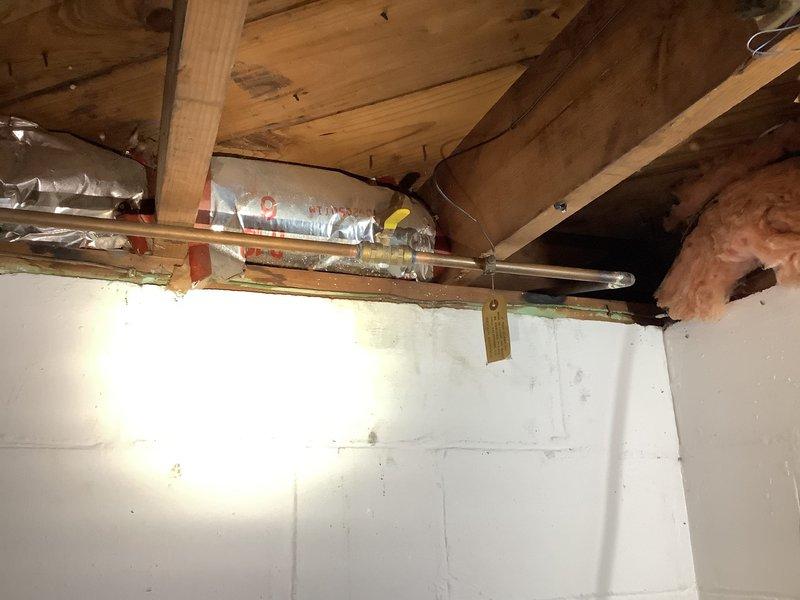 Repaired leaking drain assembly under bathroom vanity by replacing deteriorated green pipe section with new PVC P-trap configuration. Installed water catch container as precautionary measure and verified proper drainage with no leaks after completion.