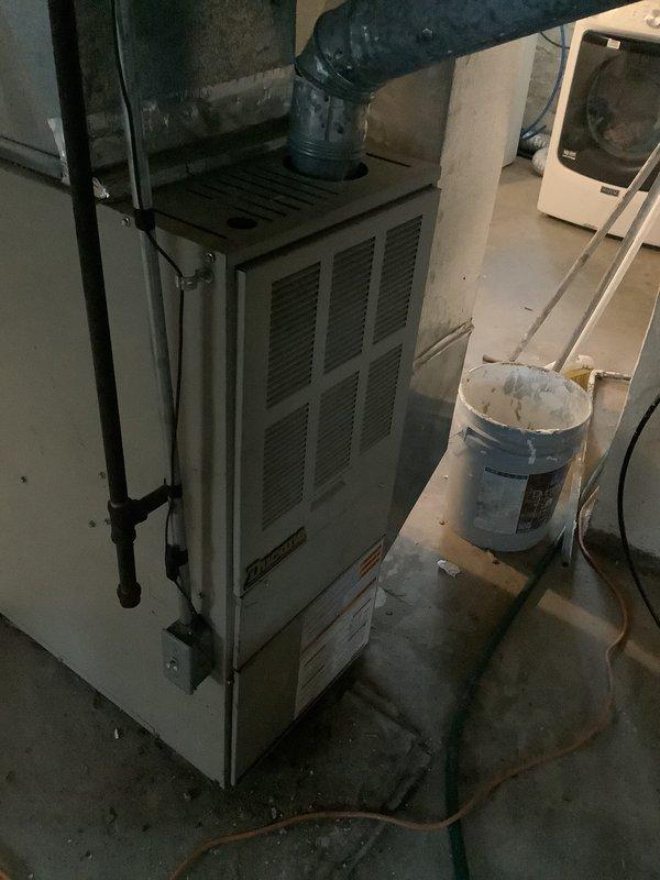 Provided comprehensive HVAC system replacement estimate for 20-year-old furnace and air conditioning unit. Customer expressed interest in promotional offer for air conditioning replacement. Documented existing equipment configuration including furnace installation in basement mechanical room and ductwork system, photographed current system components and layout for proposal specifications.