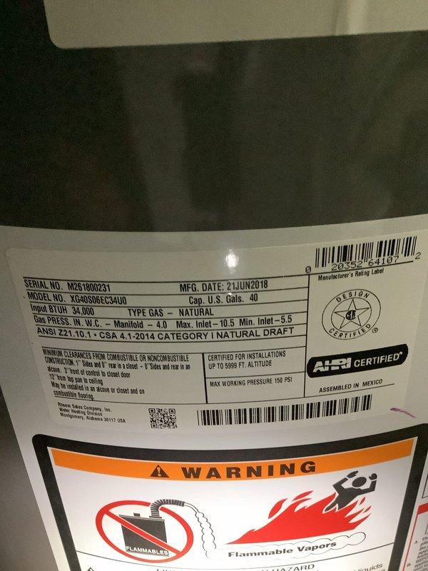 # Service Report: Water Heater Maintenance

Responded to service call for water heater not maintaining adequate hot water temperature. Upon arrival, inspected 40-gallon natural gas water heater manufactured in June 2018, located in unfinished utility area of older residential structure. Unit displayed normal exterior condition with all manufacturer labels and safety warnings intact and legible.

Performed comprehensive tank flush procedure to address sediment accumulation affecting heating efficiency. Connected drain hose to tank drain valve and systematically flushed accumulated mineral deposits and sediment from tank bottom. Continued flushing process until discharge water ran clear, indicating successful removal of buildup that was impeding heat transfer and reducing hot water capacity.

Inspected associated plumbing connections during service, noting age-appropriate patina on copper supply lines and pressure regulation assembly. All connections remained secure with no active leaks 