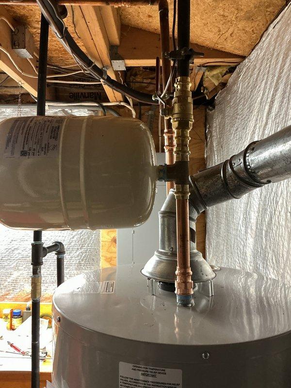 # Plumbing Service - Sold Repair Summary

Successfully installed a new 40-gallon Bradford White water heater with 6-year manufacturer warranty, including a new ball valve, thermal expansion tank, and gas line modification to relocate the fireplace tee above the water heater shutoff valve.

## Work Performed

Removed existing water heater and prepared the installation area in the basement utility space. Installed the new 40-gallon Bradford White residential water heater in compliance with manufacturer specifications and local plumbing codes.

Connected a new cream-colored thermal expansion tank to the cold water supply line using copper piping and brass fittings. The expansion tank was properly mounted and secured above the water heater unit to manage thermal expansion and protect the system from excessive pressure buildup.

Installed a new ball valve on the water supply line to provide proper shutoff capability for future maintenance and emergency situations. All water connections were