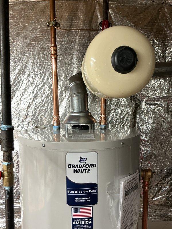 # Plumbing Service - Sold Repair Summary

Successfully installed a new 40-gallon Bradford White water heater with 6-year manufacturer warranty, including a new ball valve, thermal expansion tank, and gas line modification to relocate the fireplace tee above the water heater shutoff valve.

## Work Performed

Removed existing water heater and prepared the installation area in the basement utility space. Installed the new 40-gallon Bradford White residential water heater in compliance with manufacturer specifications and local plumbing codes.

Connected a new cream-colored thermal expansion tank to the cold water supply line using copper piping and brass fittings. The expansion tank was properly mounted and secured above the water heater unit to manage thermal expansion and protect the system from excessive pressure buildup.

Installed a new ball valve on the water supply line to provide proper shutoff capability for future maintenance and emergency situations. All water connections were