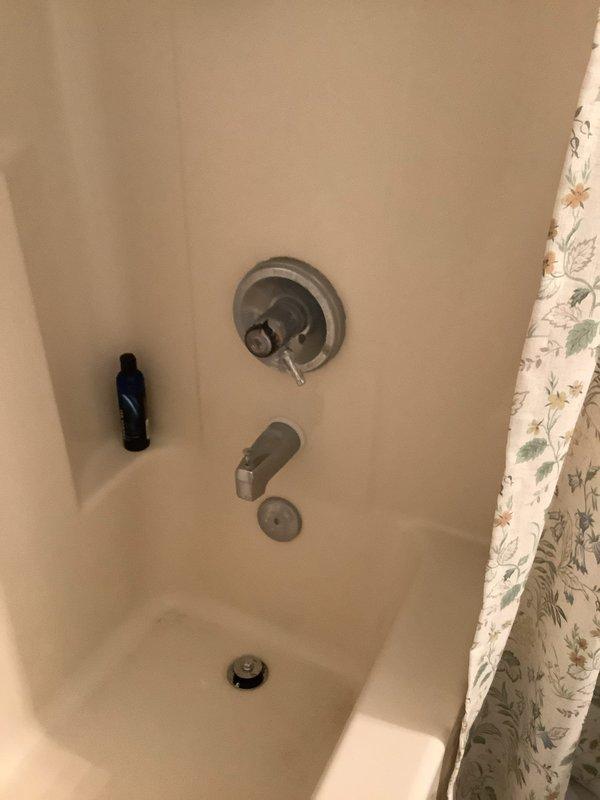 # Shower Faucet Replacement - Two Bathrooms

Replaced obsolete shower faucets in two bathrooms due to discontinued cartridge availability. Removed existing bronze-finished valve assemblies and installed new chrome shower control valves with matching tub spouts and diverters. Work included minor drywall access and repair to accommodate new fixture installation, ensuring proper wall mounting and watertight seals. All fixtures tested and confirmed operational upon completion.