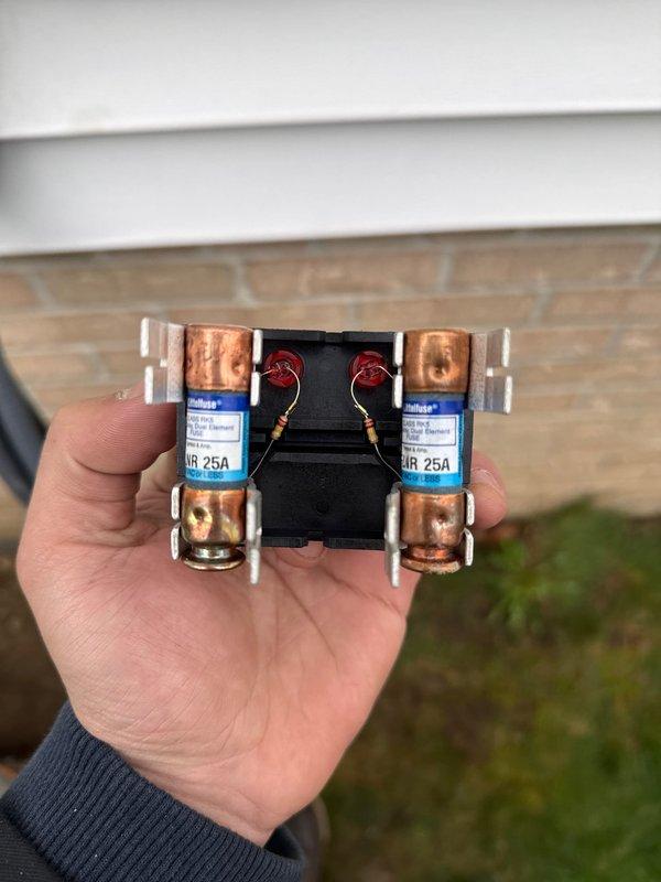 Completed outdoor unit installation for Lennox air conditioning system. Unit was properly mounted on pad with appropriate clearances, electrical disconnect and 25-amp fusing installed per manufacturer specifications, and conduit run secured to building exterior. All connections tested and system confirmed operational.