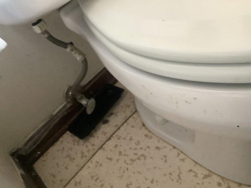 # Service Summary

Responded to service call for leaking toilet in upstairs bathroom of 1973-built single-family residence. Inspected toilet assembly, identified source of leak, and performed necessary adjustments to restore proper function and eliminate water seepage.

# Work Performed

Upon arrival, conducted thorough visual inspection of the toilet assembly including tank, bowl, supply line, and floor-mounted connections. Examined the chrome braided supply line and shut-off valve for signs of moisture or deterioration. Assessed the tank-to-bowl connection, flush valve assembly, and fill valve operation to isolate the leak source.

Identified worn flapper valve and deteriorated tank-to-bowl gasket as primary causes of water leakage. Shut off water supply at the wall-mounted valve and drained the tank completely. Removed tank lid and disconnected supply line from tank inlet. Unbolted tank from bowl to access and replace the compromised rubber gasket between components.

Installed new 