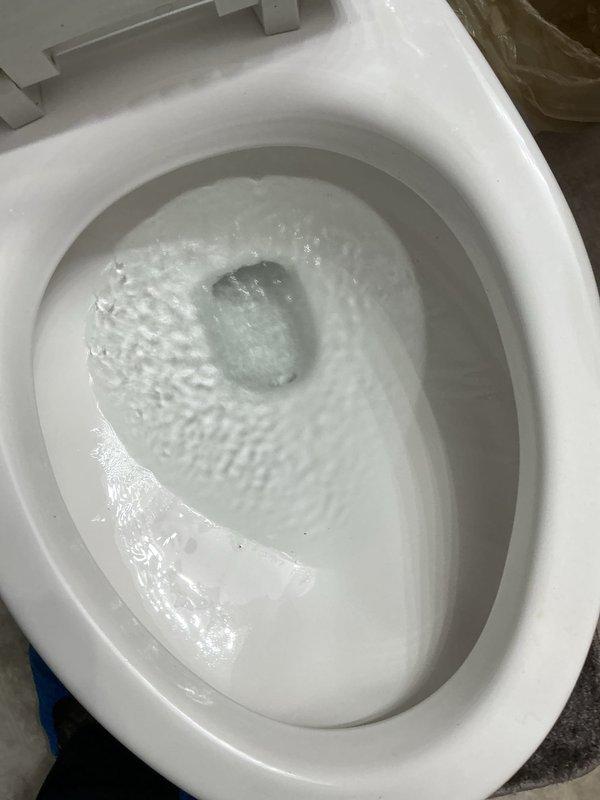 # Service Report: Toilet Water Discoloration Investigation

Responded to service call regarding yellow-colored water appearing in both toilets within a condominium unit. Upon arrival, conducted thorough inspection of toilet tanks and flushing mechanisms to diagnose the source of discoloration. Inspected internal tank components including float assembly, fill valve, flapper mechanism, and flush valve for signs of deterioration, rust, or sediment buildup that could cause water discoloration. Documented existing mineral deposits and sediment accumulation on tank floor and components. Performed flush cycle testing to observe water flow patterns and verify proper toilet operation. Determined discoloration was not originating from internal toilet components. Based on findings and the issue affecting multiple fixtures in the unit, advised customer that yellow water discoloration likely stems from building-wide plumbing system, potentially related to municipal water supply issues or aging galv